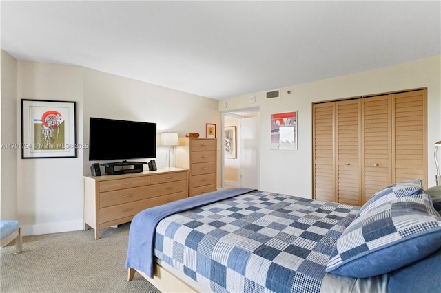 bedroom with light colored carpet, a closet, and visible vents