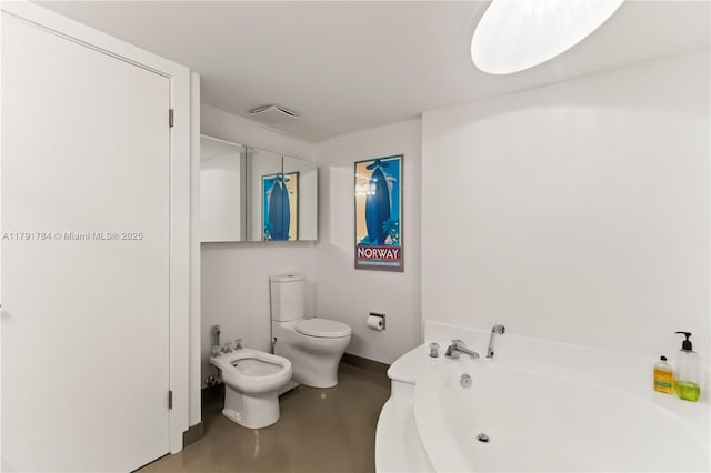 bathroom featuring finished concrete floors, a bidet, toilet, and a garden tub
