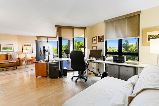 2000 Towerside Ter Unit 710, Miami, FL 33138 - bedroom with multiple windows, a desk, light wood-style flooring, and expansive windows