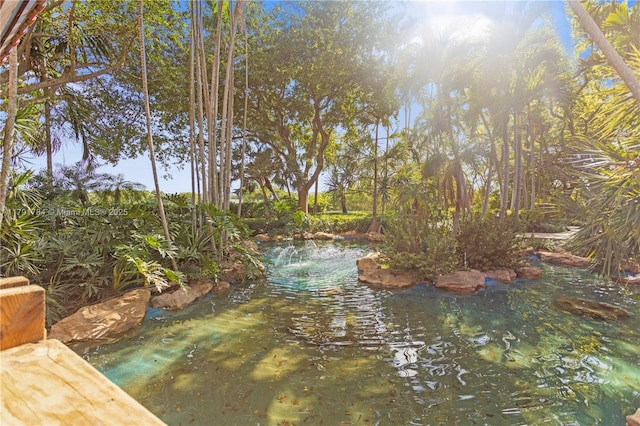property view of water with a garden pond
