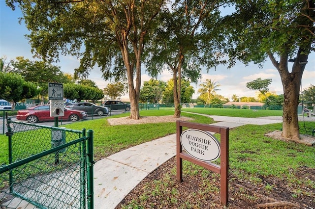 view of home's community with a gate, fence, and a yard
