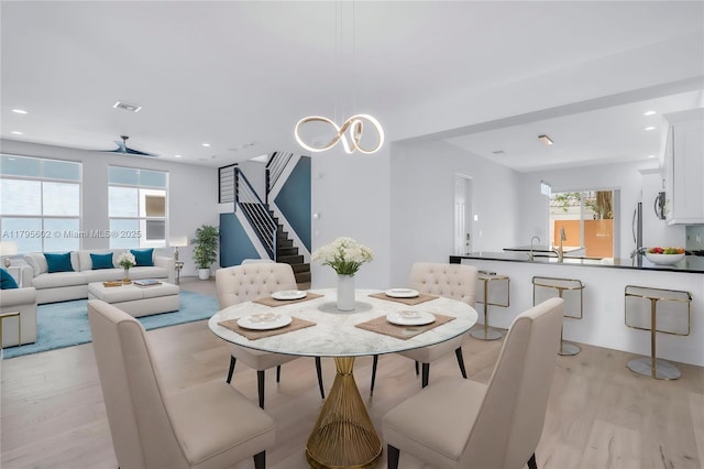 3040 NW 126th Ave, Sunrise, FL 33323 - dining area featuring light wood finished floors, plenty of natural light, stairway, a chandelier, and recessed lighting