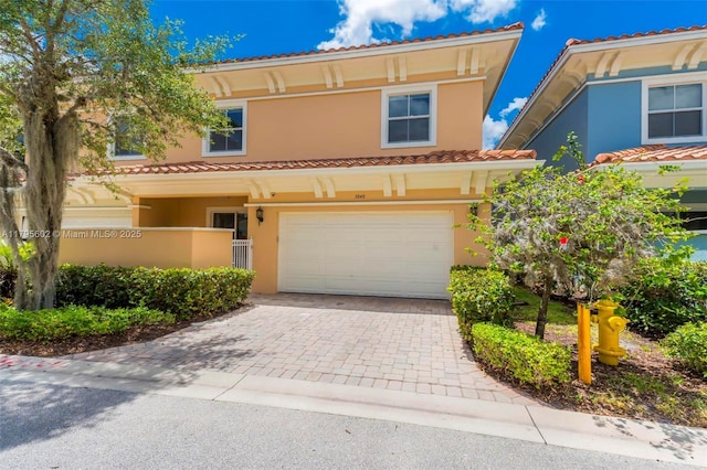 3040 NW 126th Ave, Sunrise, FL 33323 - view of front of property with an attached garage, a tiled roof, stucco siding, and decorative driveway