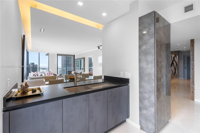 ensuite bathroom featuring vanity, connected bathroom, and visible vents