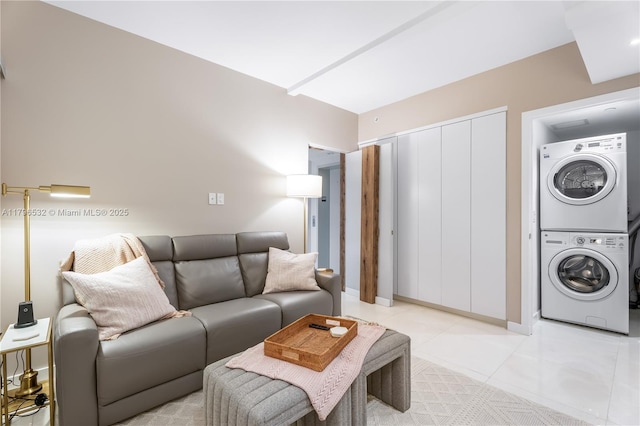 living room with light tile patterned floors and stacked washer / dryer