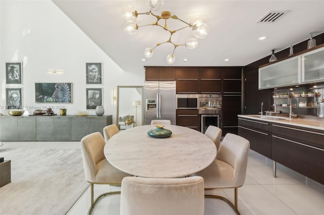 6000 Collins Ave Unit 304, Miami Beach, FL 33140 - dining area with light tile patterned floors, visible vents, indoor wet bar, and a notable chandelier