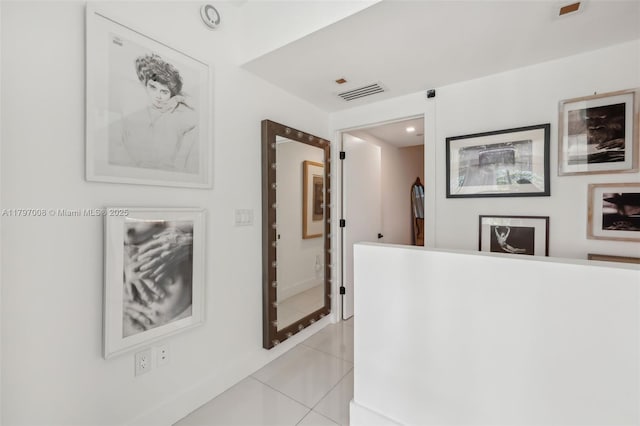 6000 Collins Ave Unit 304, Miami Beach, FL 33140 - corridor with baseboards, light tile patterned floors, and visible vents