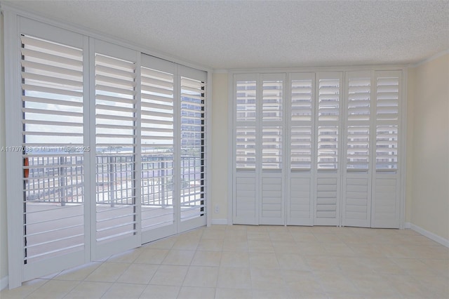 1865 Brickell Ave Unit A514, Miami, FL 33129 - tiled spare room with a textured ceiling and baseboards