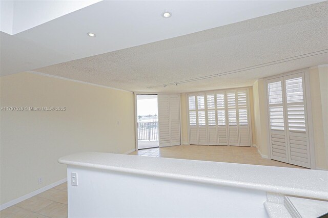 1865 Brickell Ave Unit A514, Miami, FL 33129 - spare room with a textured ceiling, light tile patterned floors, recessed lighting, and baseboards