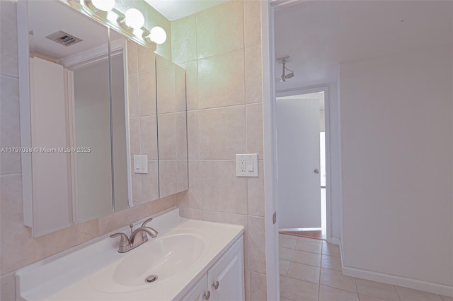 1865 Brickell Ave Unit A514, Miami, FL 33129 - bathroom featuring vanity, tile patterned floors, and tile walls