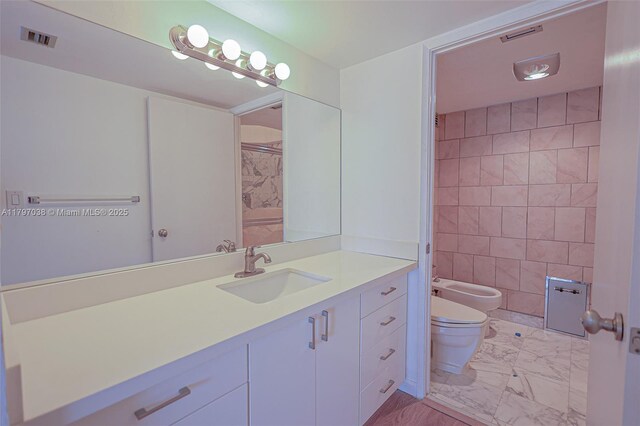 1865 Brickell Ave Unit A514, Miami, FL 33129 - full bathroom with marble look tiles, toilet, a bidet, vanity, and a shower