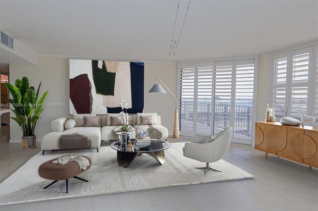 1865 Brickell Ave Unit A514, Miami, FL 33129 - tiled living area with a wall of windows and a textured ceiling