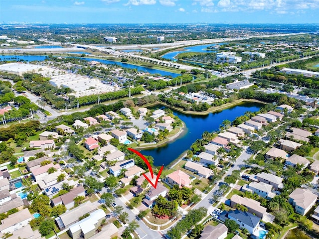 birds eye view of property with a water view and a residential view