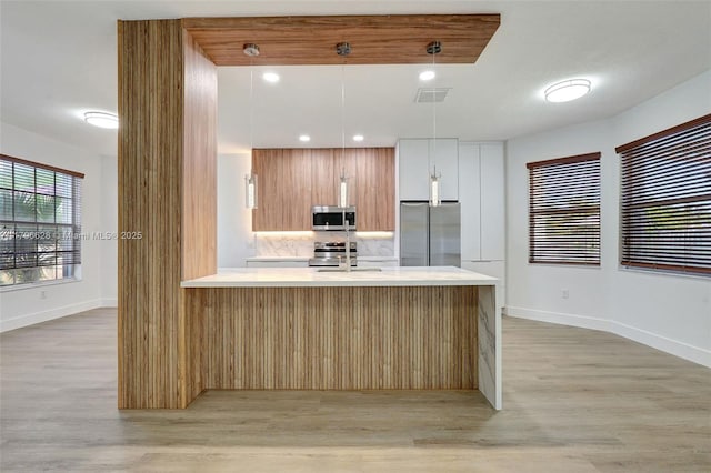 16276 SW 29th St, Miramar, FL 33027 - kitchen featuring appliances with stainless steel finishes, light countertops, modern cabinets, and light wood finished floors