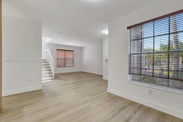16276 SW 29th St, Miramar, FL 33027 - unfurnished room with light wood-style floors, baseboards, and stairway