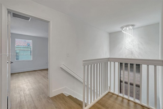 16276 SW 29th St, Miramar, FL 33027 - hall featuring an upstairs landing, wood finished floors, baseboards, and a chandelier