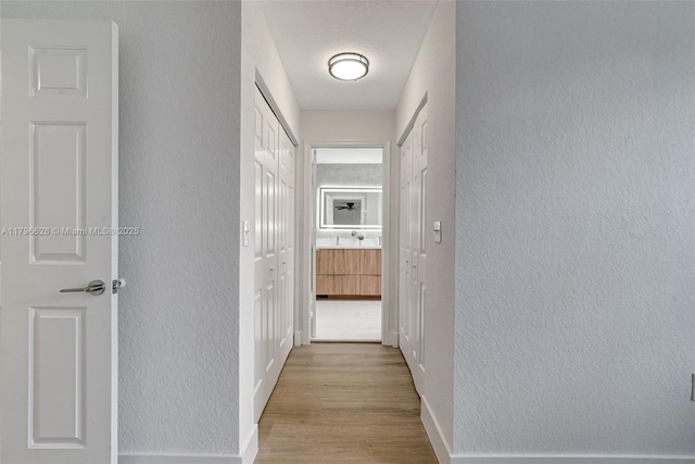 16276 SW 29th St, Miramar, FL 33027 - hall featuring a textured wall, wood finished floors, and baseboards