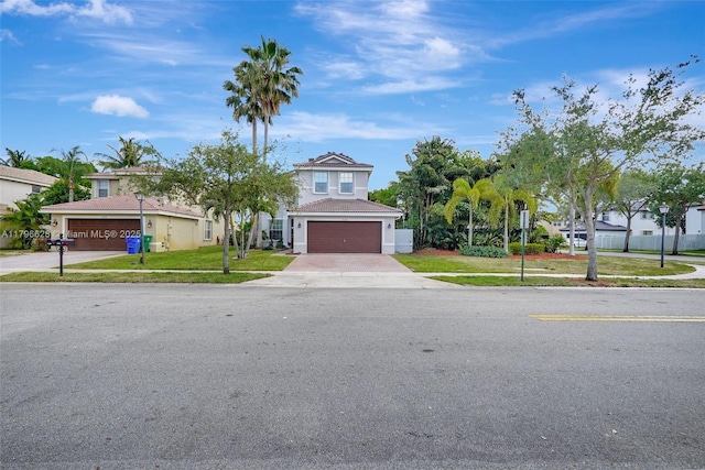 mediterranean / spanish-style house with a front lawn, stucco siding, and driveway