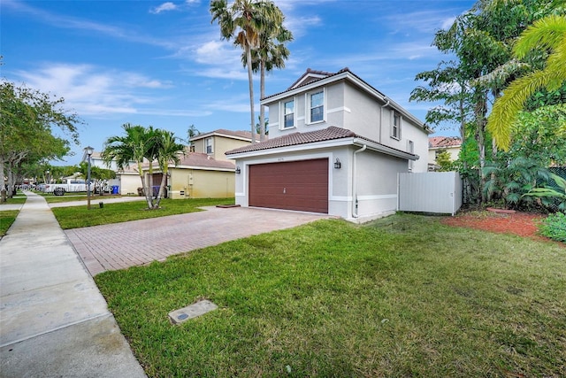 traditional-style house featuring a front lawn, stucco siding, driveway, and a garage