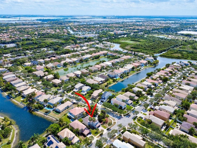 birds eye view of property featuring a water view and a residential view