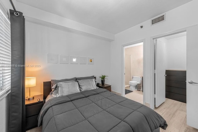 1300 Pennsylvania Ave Unit 104, Miami Beach, FL 33139 - bedroom with ensuite bathroom, light wood-style flooring, and visible vents
