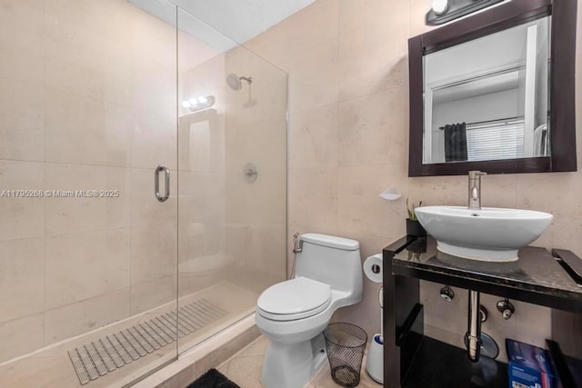 1300 Pennsylvania Ave Unit 104, Miami Beach, FL 33139 - full bathroom with toilet, a sink, tile patterned floors, tile walls, and a shower stall