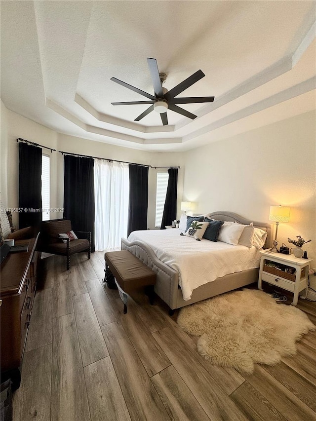 16724 NW 8th St, Pembroke Pines, FL 33028 - bedroom featuring a raised ceiling, wood finished floors, a ceiling fan, and multiple windows