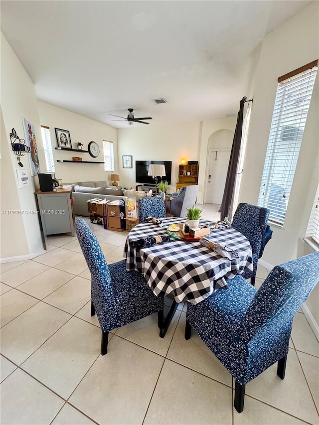 16724 NW 8th St, Pembroke Pines, FL 33028 - dining space featuring baseboards, arched walkways, a ceiling fan, and light tile patterned floors