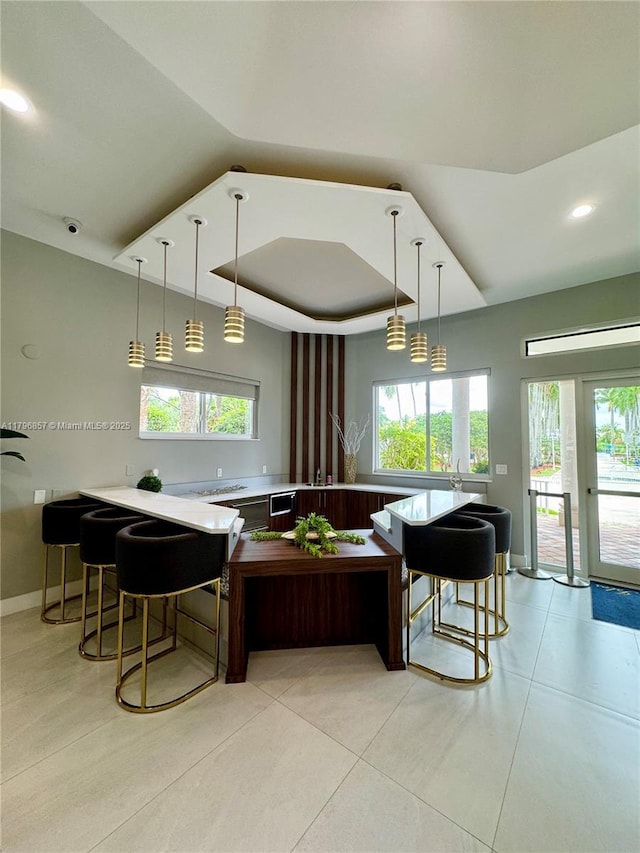 16724 NW 8th St, Pembroke Pines, FL 33028 - kitchen with hanging light fixtures, light countertops, plenty of natural light, and light tile patterned floors