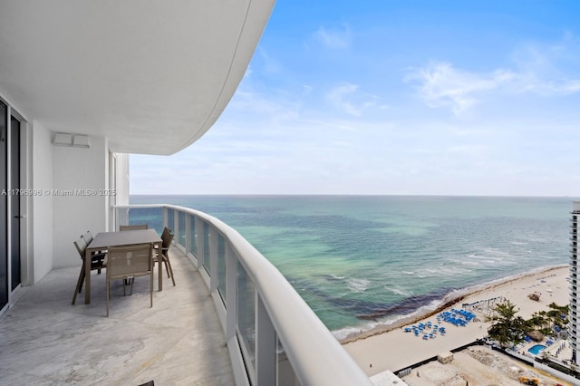 balcony featuring view of water and beach