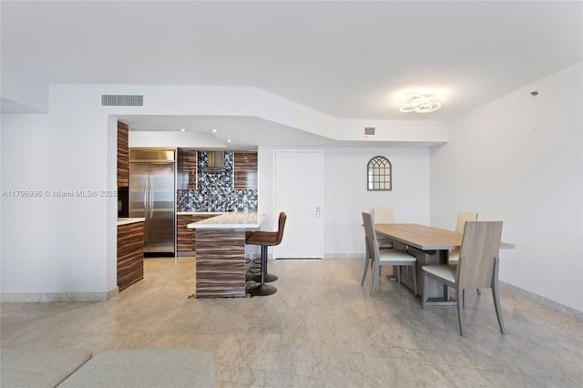dining space featuring baseboards and recessed lighting