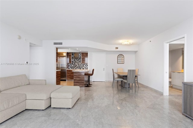 living area featuring light marble finish flooring