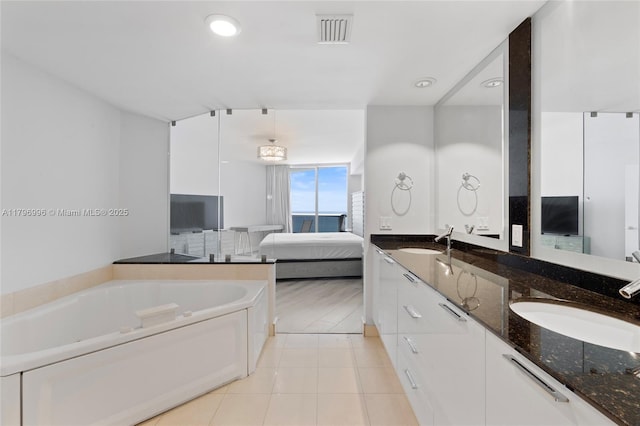 bathroom with connected bathroom, double vanity, a bath, tile patterned flooring, and recessed lighting
