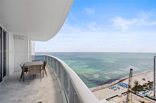 balcony with view of water and beach