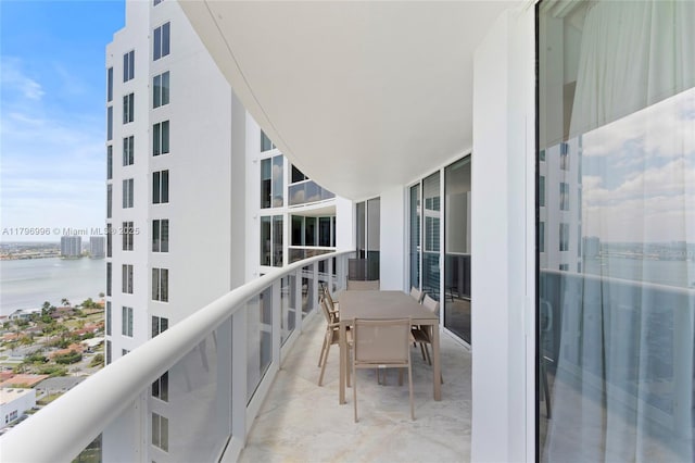 balcony featuring a water view and cooling unit
