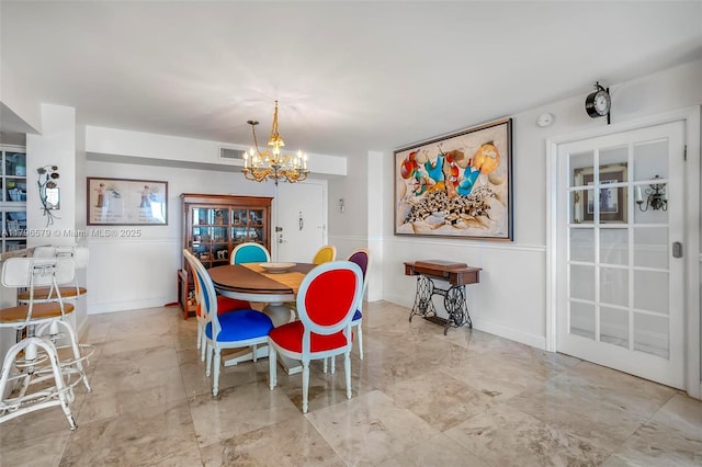 dining room with an inviting chandelier and visible vents