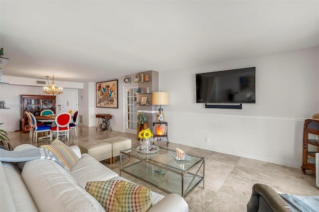 living area with a chandelier and baseboards