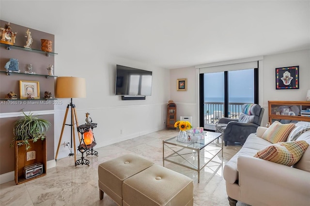 living room featuring marble finish flooring and baseboards