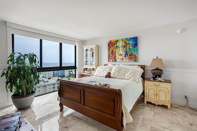 bedroom with light marble finish floors and baseboards