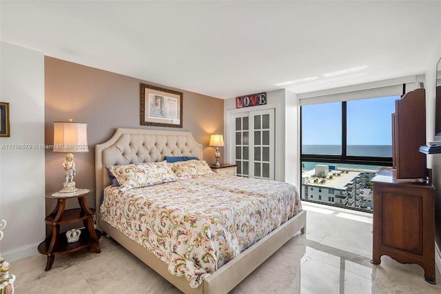 bedroom featuring baseboards and light tile patterned floors