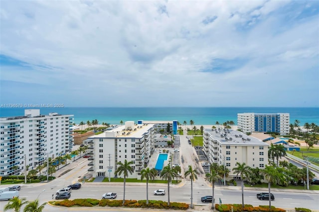 drone / aerial view of a nearby body of water and apartment complex