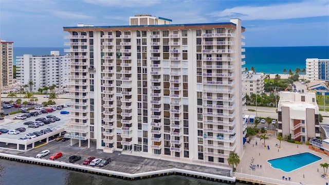 view of apartment building / complex with a water view and a view of city