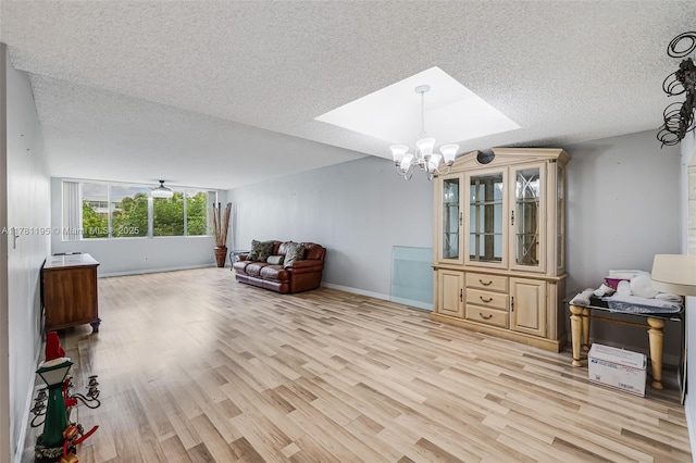 6698 N 10th Ave N Unit 218, Lake Worth, FL 33467 - living area with a textured ceiling, a notable chandelier, light wood-style flooring, and baseboards