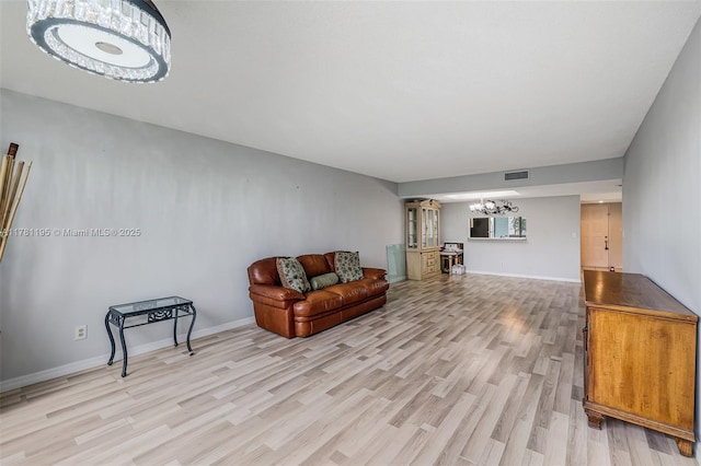 6698 N 10th Ave N Unit 218, Lake Worth, FL 33467 - living room with an inviting chandelier, baseboards, light wood finished floors, and visible vents