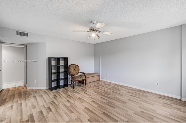 6698 N 10th Ave N Unit 218, Lake Worth, FL 33467 - sitting room featuring a textured ceiling, visible vents, ceiling fan, light wood-style flooring, and baseboards