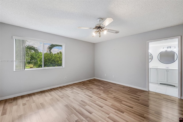 6698 N 10th Ave N Unit 218, Lake Worth, FL 33467 - empty room with a textured ceiling, light wood-style flooring, and a ceiling fan