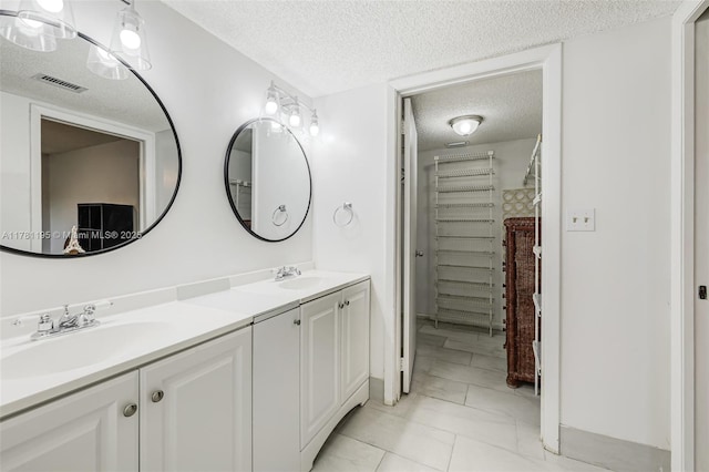 6698 N 10th Ave N Unit 218, Lake Worth, FL 33467 - full bathroom with a sink, double vanity, a textured ceiling, and visible vents