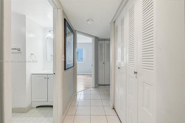 6698 N 10th Ave N Unit 218, Lake Worth, FL 33467 - hall featuring baseboards and light tile patterned floors