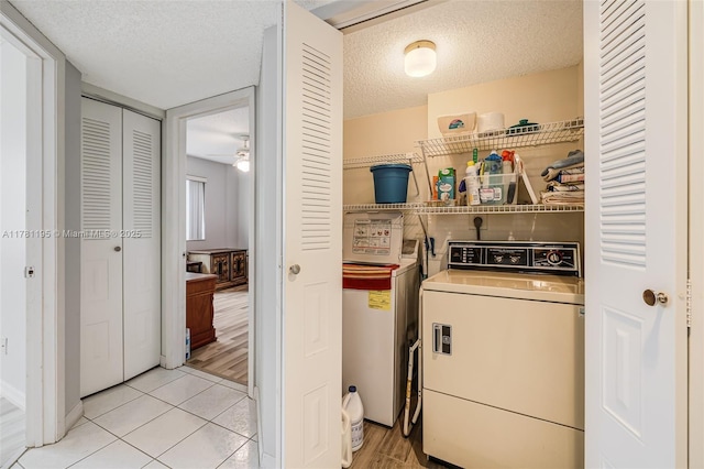 6698 N 10th Ave N Unit 218, Lake Worth, FL 33467 - laundry room with laundry area, washer and clothes dryer, light tile patterned floors, and a textured ceiling
