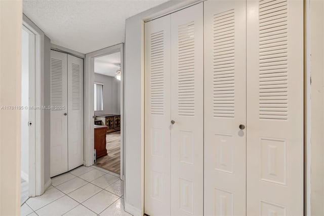 6698 N 10th Ave N Unit 218, Lake Worth, FL 33467 - hall with light tile patterned floors, baseboards, and a textured ceiling